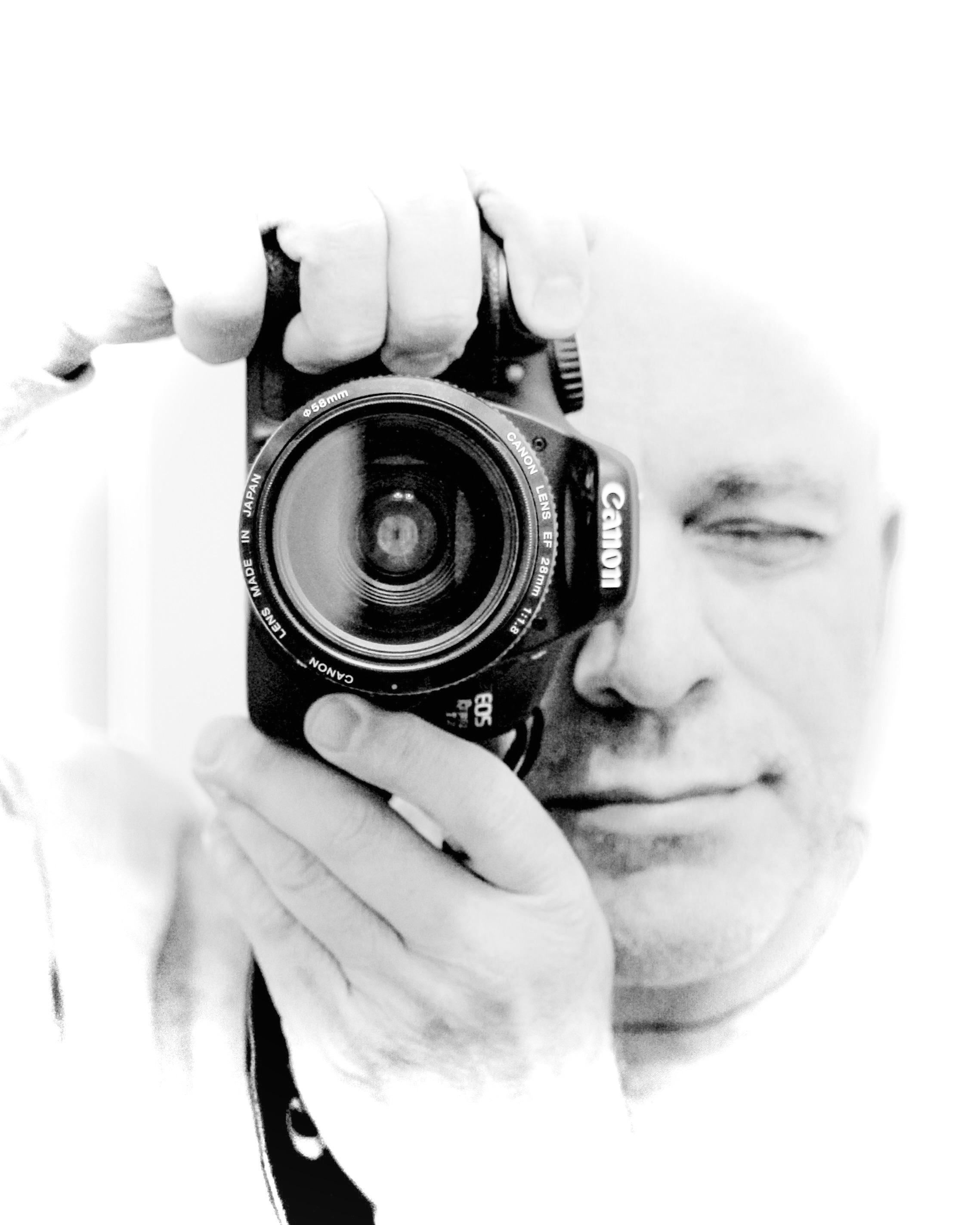Daniel Swartz holding a Canon EOS camera to his eye